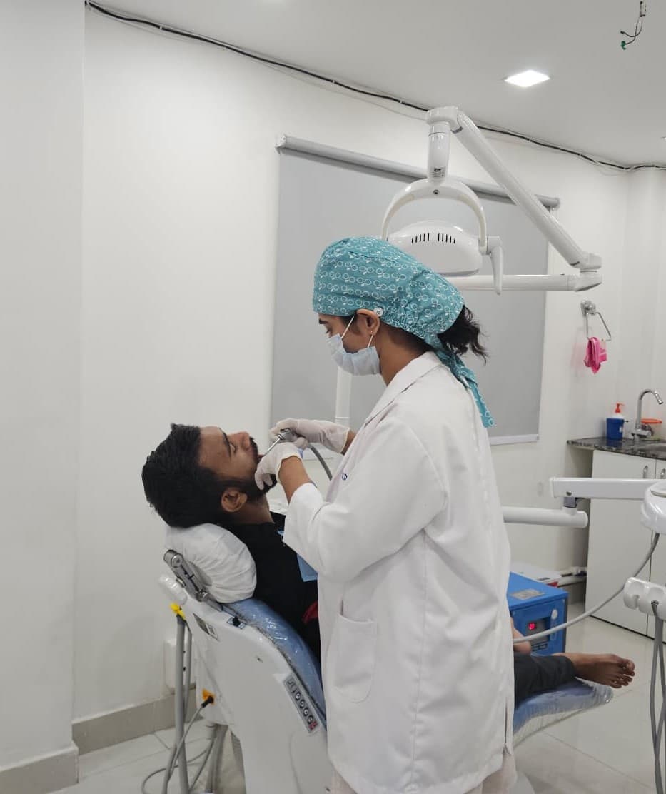Modern high-end dental surgery room with teal accents, sterile equipment, and soft natural lighting creating a calm atmosphere